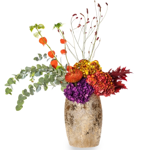 High golden vase with hydrangeas and automn foliage