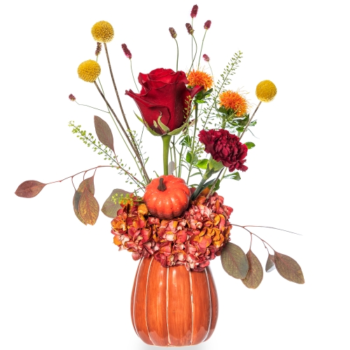 Orange pumpkin with orange and red flowers