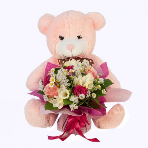 Flower bouquet with a pink teddy bear