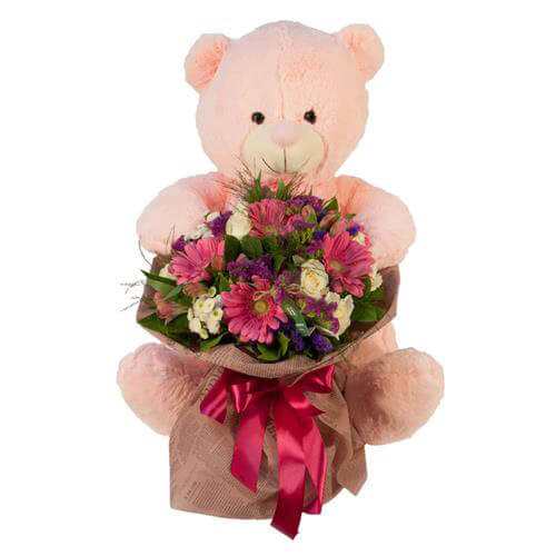 Flower bouquet in shades of pink with a teddy bear