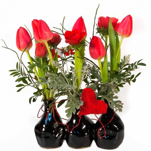 Tulips in black pottery vases