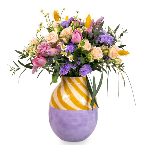 Bouquet of fresh flowers in a yellow-purple vase