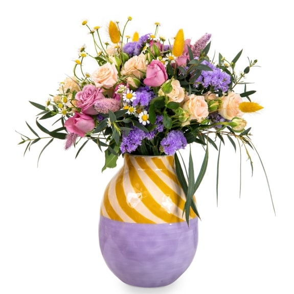 Bouquet of fresh flowers in a yellow-purple vase