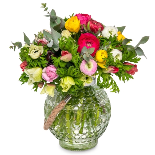 Ranunculus and anemones in a glass jar