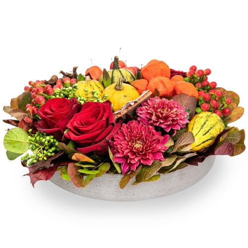 Arrangement with pumpkins and roses in a plate