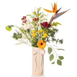 White vase with bow and light flower arrangement with strelitzias