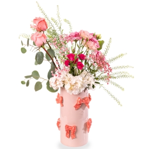 Pink vase with bows and floral arrangement with hydrangea, roses and lisianthus
