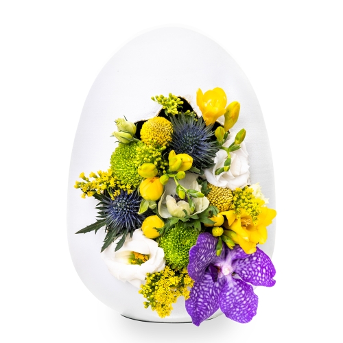 White egg with golden interior and yellow flowers with purple details