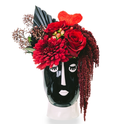 Red flowers in face vase