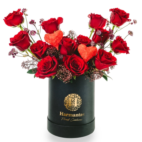 Flower arrangement with red roses in a black box