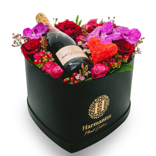 Box in heart shape with flowers and champagne