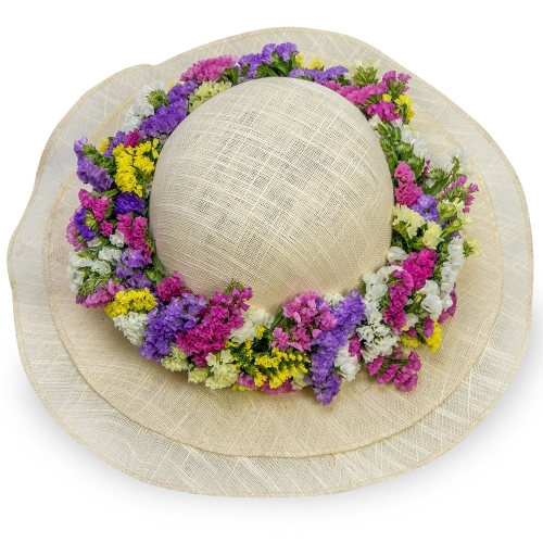 Wicker hat with a colourful first of may wreath