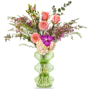 Green glass vase with hydrangea, gerbera, lisianthus and wax flower