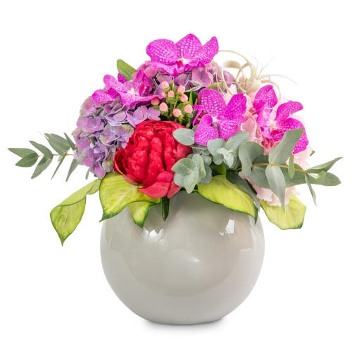 Orchids and peonies bouquet in a glossy fiberstone vaze